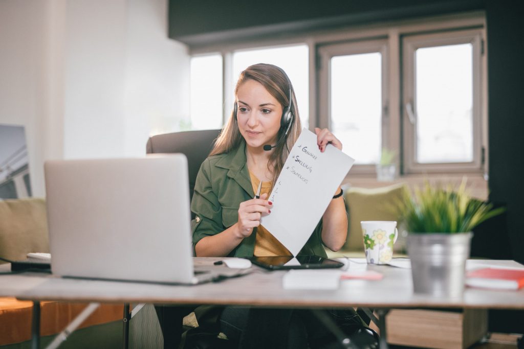Young English teacher giving online lessons