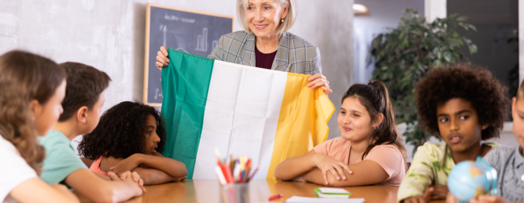 Non-Irish teacher leading a class in Ireland, showing the Irish flag, illustrating TEFL in Ireland for non-Irish citizens