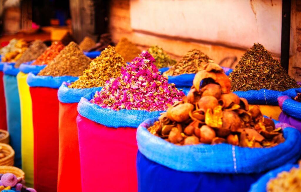Open sacks of spices in a Moroccan market illustrating the low cost of living on a TEFL salary