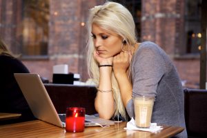 Woman with laptop on cafe, teaching english online in china