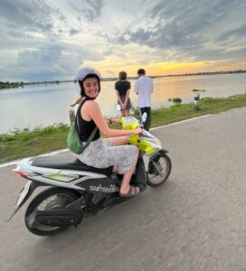 Thailand Internship/ free resources, Solo traveller on a bicycle in Thailand with a beautiful valley view, showing the freedom of TEFL solo travel in one of the safest countries to teach English abroad solo.
