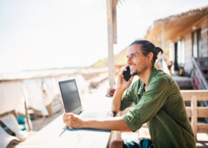 Digital nomad managing TEFL affiliate work from a beachside café