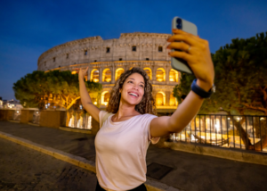 Travel influencer taking a selfie in front of a famous landmark while on TEFL travels