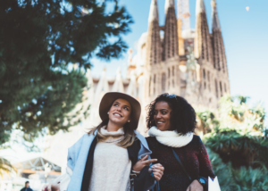 Two friends exploring the Spanish city of Barcelona after their English classes, showing the social side of teaching abroad with La Sagridia Familia behind them