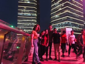 Group of TEFL interns exploring a modern city at night during their teach English abroad programme