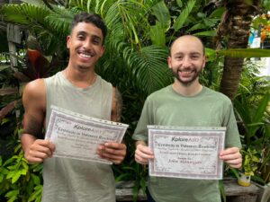 Two TEFL volunteers holding teaching certificates after completing a teaching placement abroad