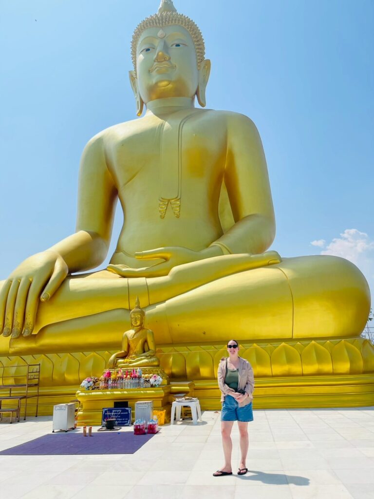 TEFL teacher visiting the Big Buddha in Thailand during a weekend trip while teaching English abroad.