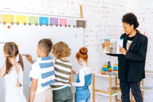 Teacher leading a colourful classroom activity, one of the seasonal TEFL jobs in Spain at a summer camp