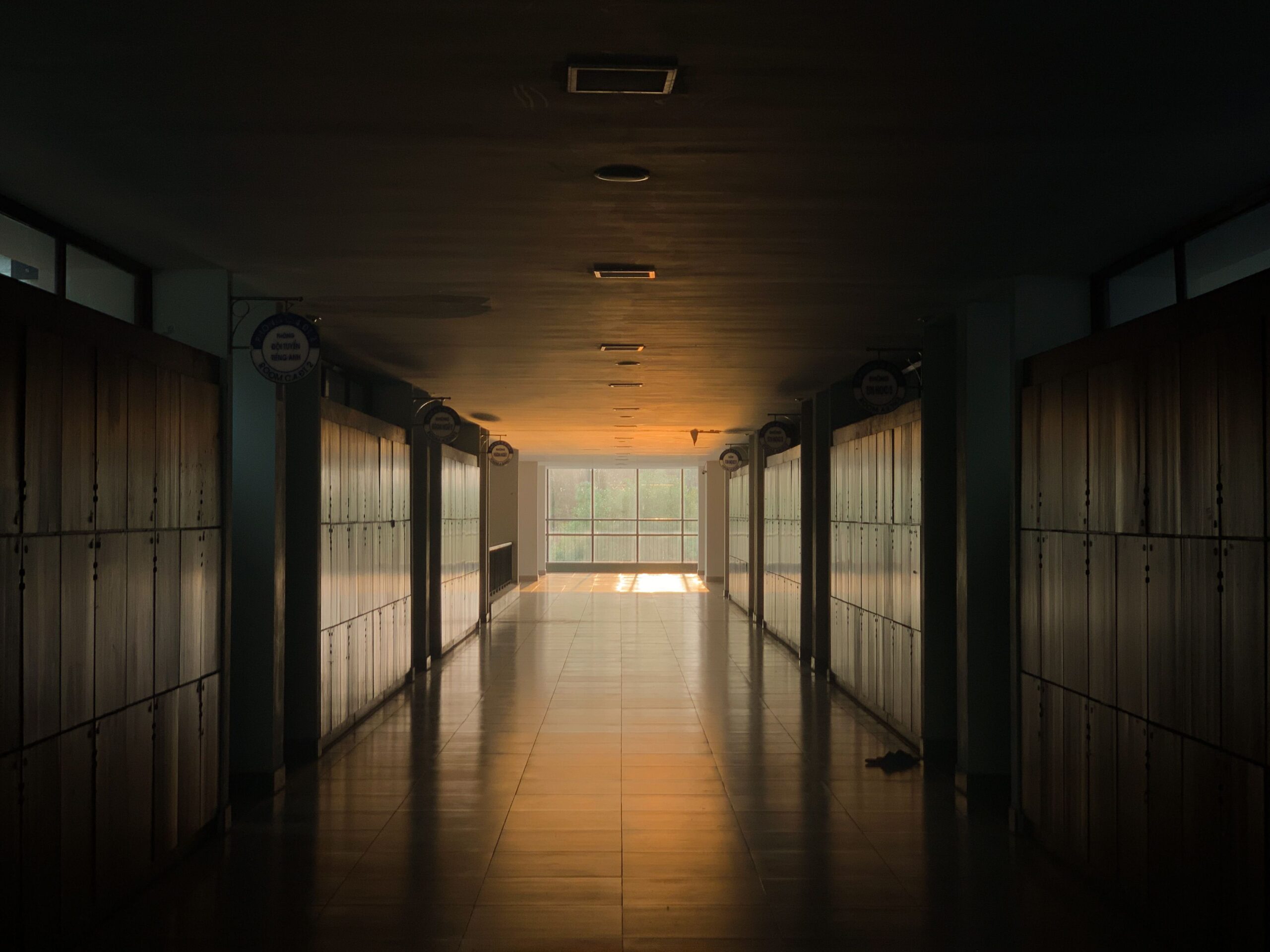 Sunlit empty school corridor lined with lockers where Transition Year students move between modules